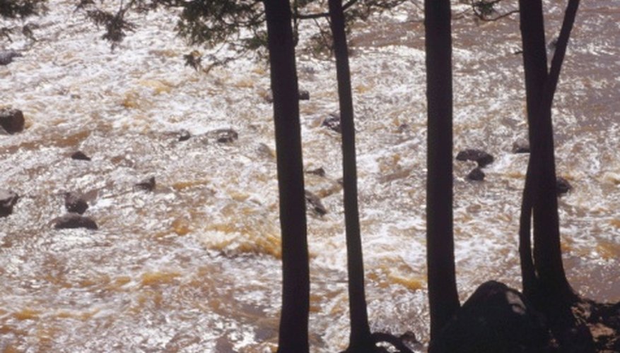 Photo Credit: Jupiterimages/Photos.com/Getty Images Fast-flowing water will carry more sediment than tranquil water.