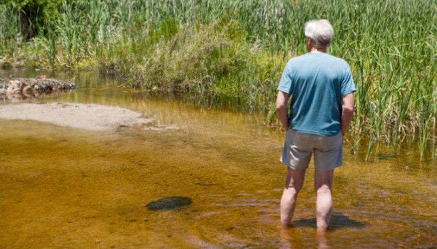 Photo Credit: Jupiterimages/BananaStock/Getty Images Streams can change the surrounding geography over the course of many years.