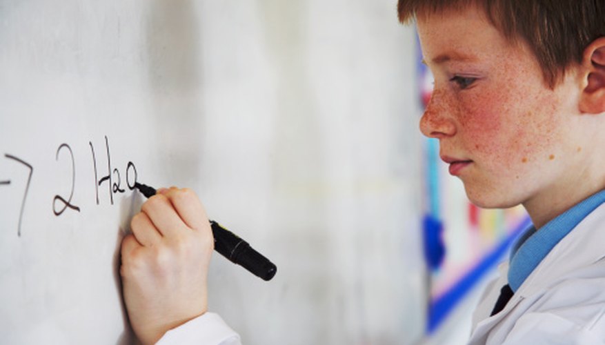 Photo Credit: Ableimages/Lifesize/Getty Images A student is writing the products of a decomposition reaction.