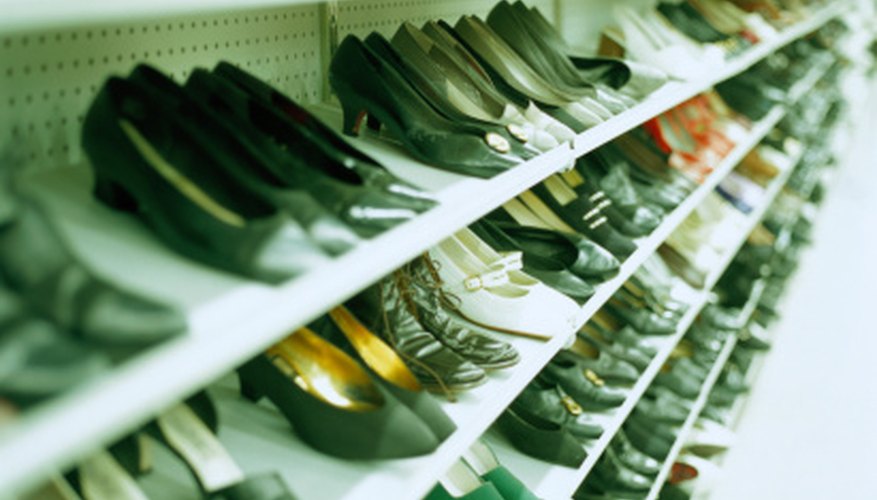 Photo Credit: Ryan McVay/Photodisc/Getty Images Shoes in thrift stores can also be organized on display racks by color and size.