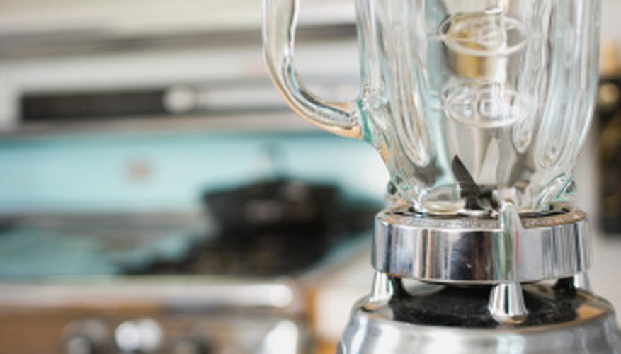 Photo Credit: Jupiterimages, Brand X Pictures/Brand X Pictures/Getty Images Use a regular kitchen blender to blend the oranges.