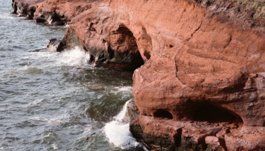 Photo Credit: Jupiterimages/Photos.com/Getty Images Even small amounts of iron produce a red color in sandstone.