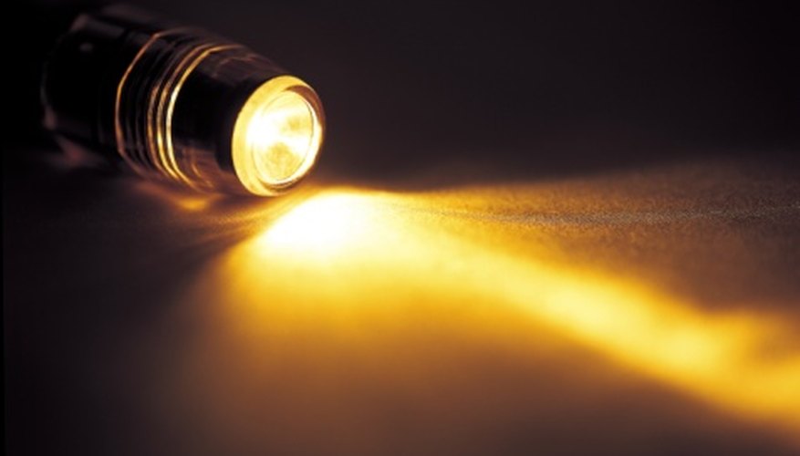 Photo Credit: Jupiterimages/Photos.com/Getty Images The flow of electrons from zinc to copper produces enough current to power a small flashlight bulb.
