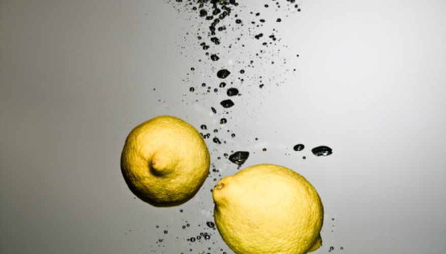 Photo Credit: Jupiterimages/Photos.com/Getty Images Citric acid in lemons reacts with the carbon dioxide in Pop Rocks.