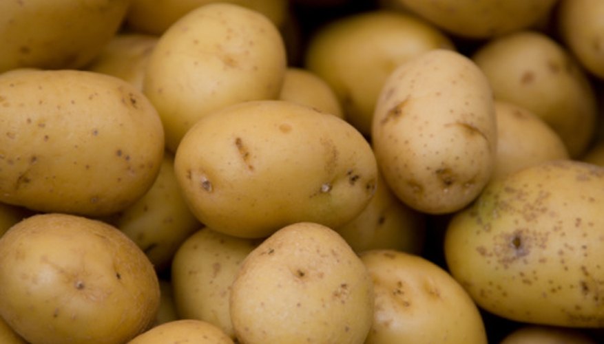 Photo Credit: Jupiterimages/Photos.com/Getty Images Potatoes contain phosphoric acid, which facilitates chemical reactions.