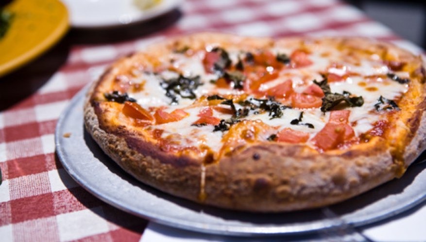 Photo Credit: Jupiterimages/Photos.com/Getty Images An Italian restaurant won't seem like an Italian restaurant if pizza is not on the menu.