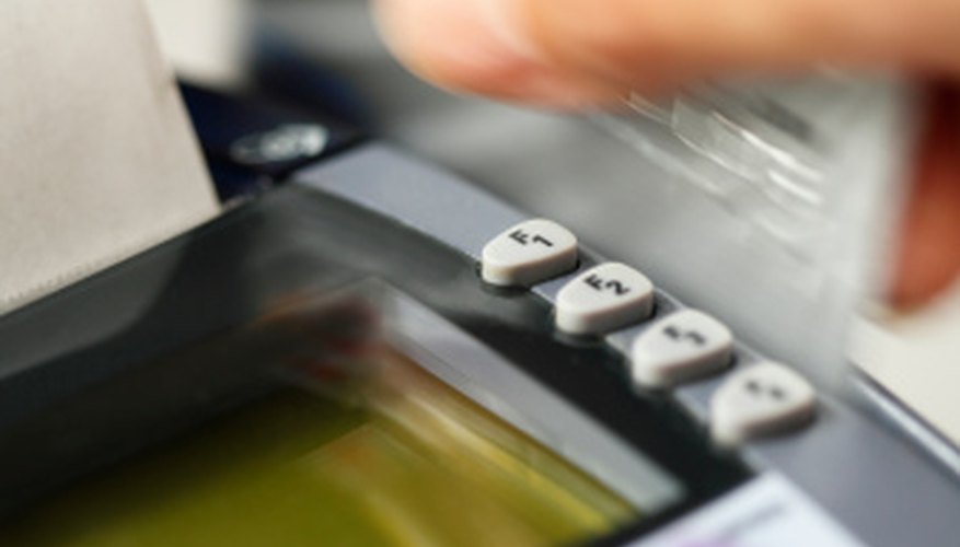 Slide the EBT card through a credit card terminal to purchase groceries.