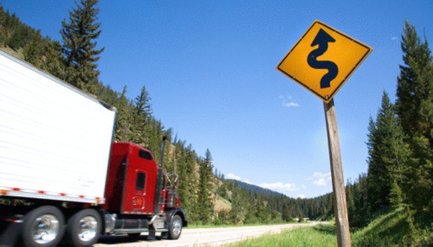 Photo Credit: Jupiterimages/Photos.com/Getty Images Truckers must switch to low gears when going down steep hills.