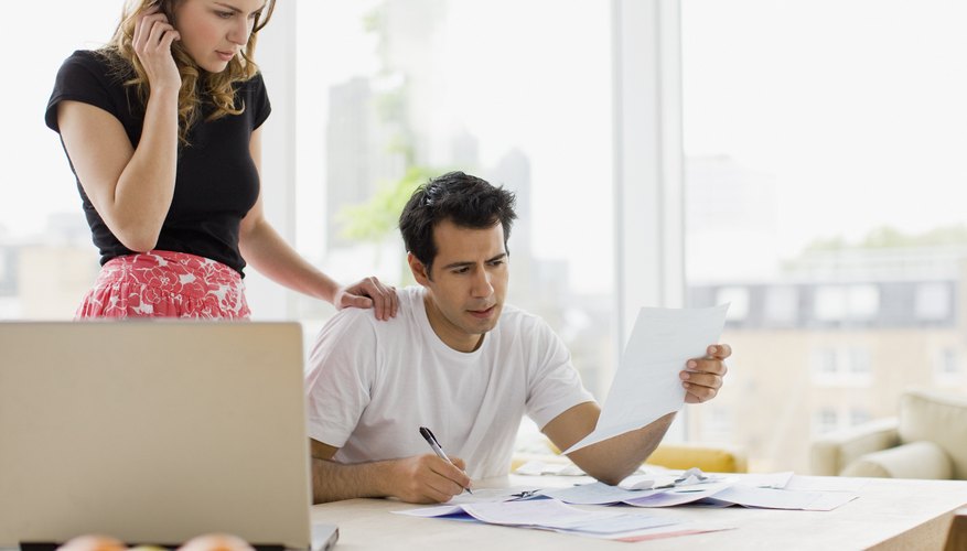 Concerned couple paying bills together