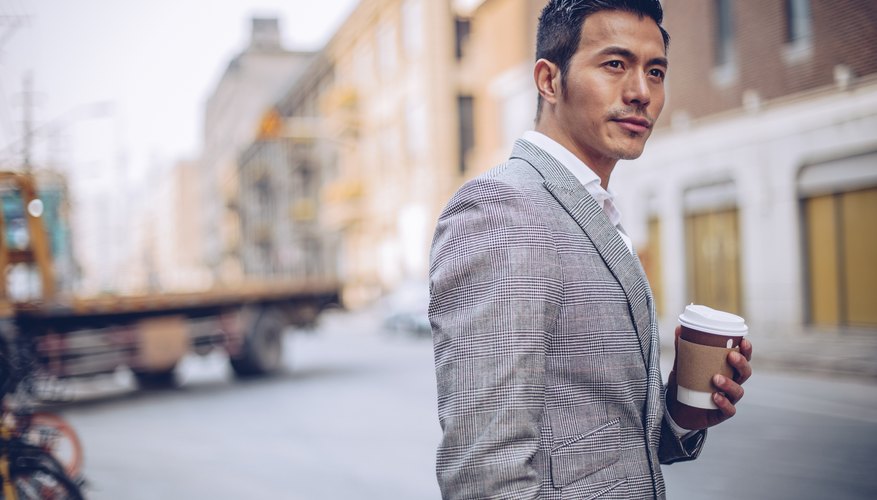 Businessman with coffee cup outdoors