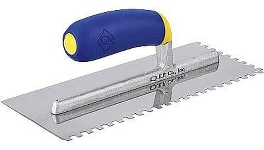 Apply the adhesive to the concrete floor. Apply the adhesive to the concrete floor.