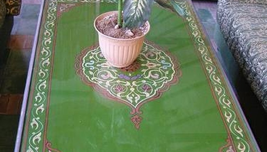 A colorful painted-wood table serves as the focus for a conversation area. A colorful painted-wood table serves as the focus for a conversation area.