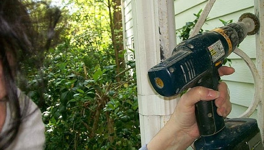 Sand the wrought iron with the wire brush. Sand the wrought iron with the wire brush.
