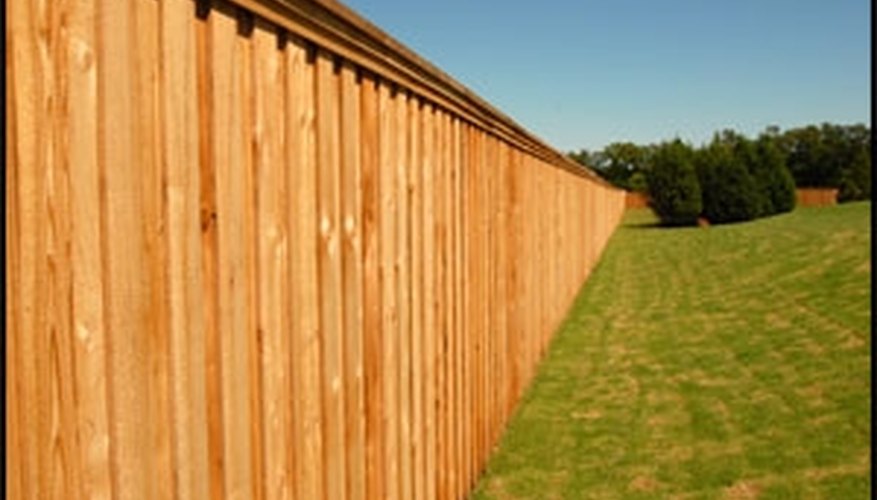 This cedar stockade style fence has a clear sealant applied to preserve the color of the wood. This cedar stockade style fence has a clear sealant applied to preserve the color of the wood.