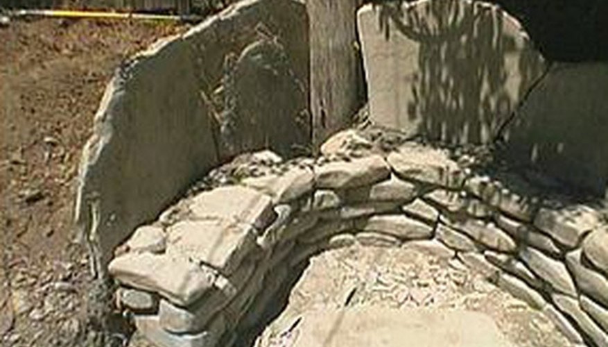 Flagstone slabs should extend 2 feet above the base. Flagstone slabs should extend 2 feet above the base.