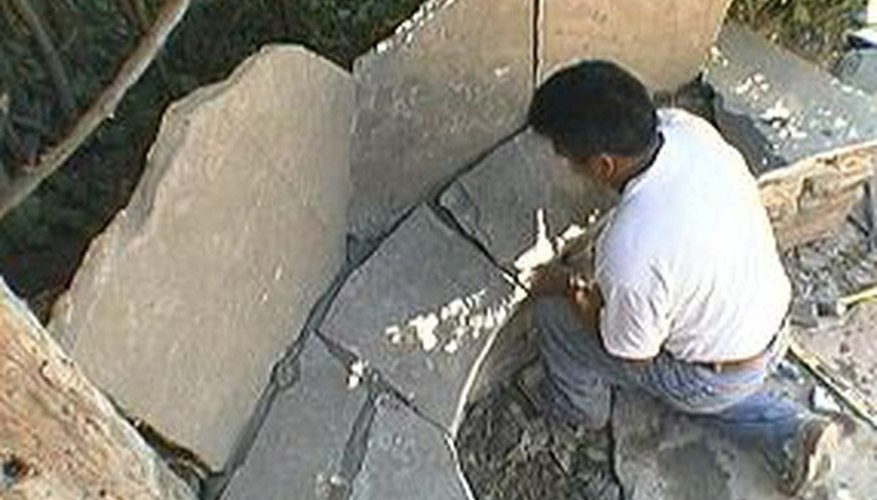 Place smaller flagstone pieces on the base. Place smaller flagstone pieces on the base.