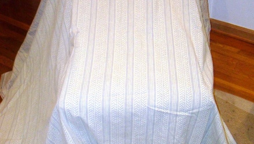 Cover the chair with the fabric. Cover the chair with the fabric.