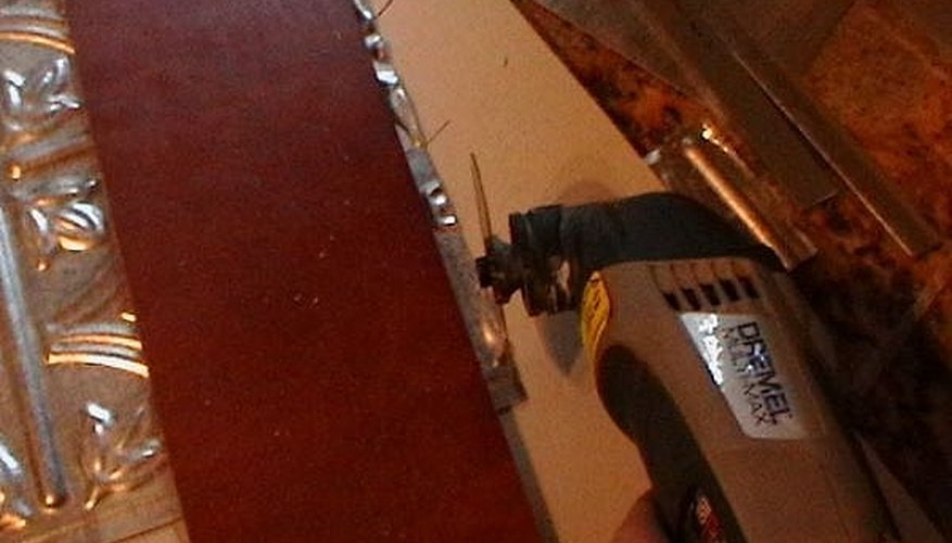 Power cutting tools make quick and easy work of cutting faux tin tile Power cutting tools make quick and easy work of cutting faux tin tile