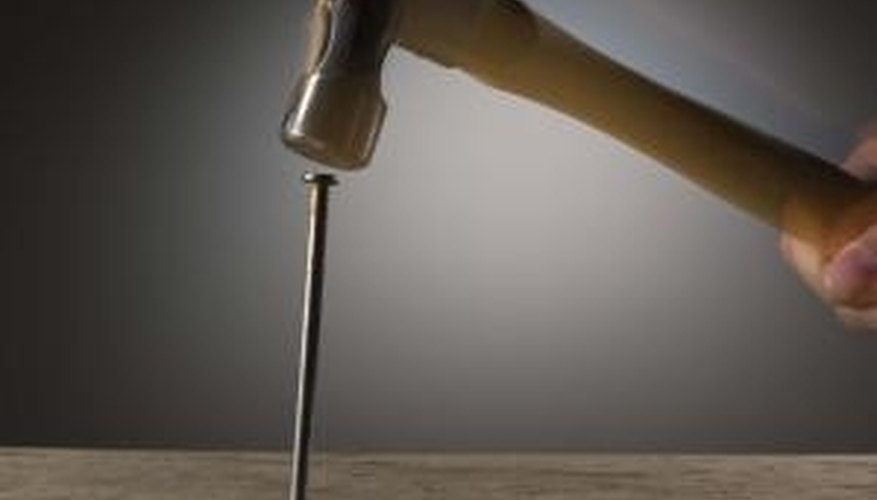 Picture-hanger hooks often come with a nail positioned at the appropriate angle. Picture-hanger hooks often come with a nail positioned at the appropriate angle.