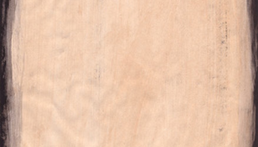 Photo Credit: grunge paper pale paper image by Andrew Brown from <a href='http://www.fotolia.com'>Fotolia.com</a> Manufacturers process and dry a slurry of fibrous plant matter to form sheets of paper.