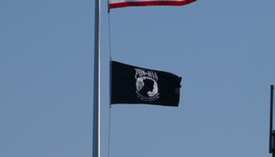 Flag poles use a single fixed pulley for raising and lowering flags. Flag poles use a single fixed pulley for raising and lowering flags.