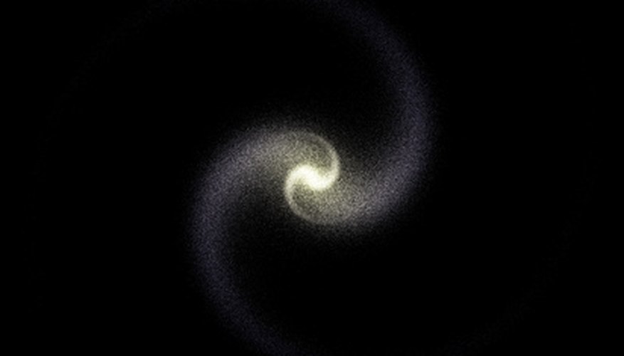 Photo Credit: galaxy image by Sergey Galushko from <a href='http://www.fotolia.com'>Fotolia.com</a> Spiral galaxies are one of the two most common types.
