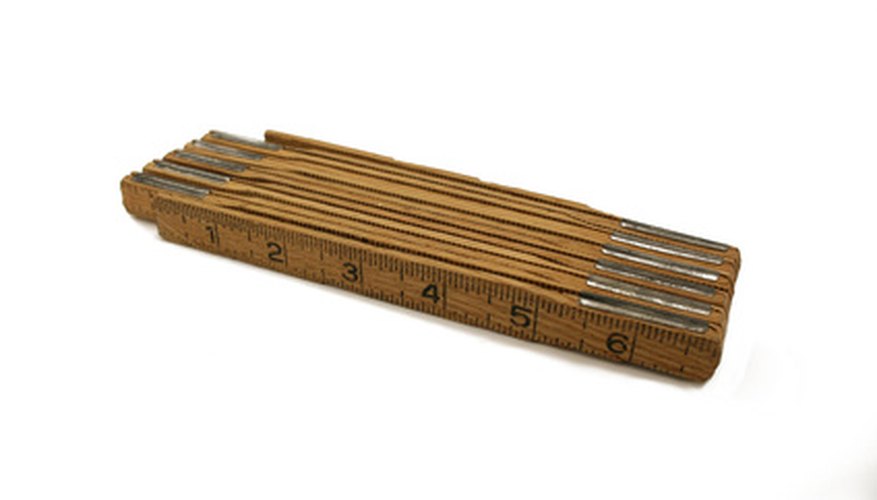 Photo Credit: wooden folding ruler image by Jim Mills from <a href='http://www.fotolia.com'>Fotolia.com</a> Brick masons use a folding ruler.