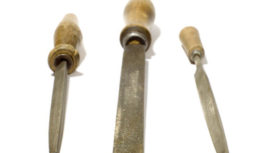 Sharpening pencil sharpener blades requires a small triangular file to reach around the twists and turns of the blades. Sharpening pencil sharpener blades requires a small triangular file to reach around the twists and turns of the blades.