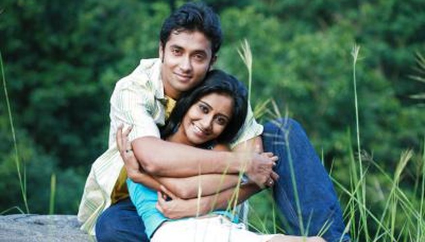 man hugging woman he loves from behind man hugging woman he loves from behind
