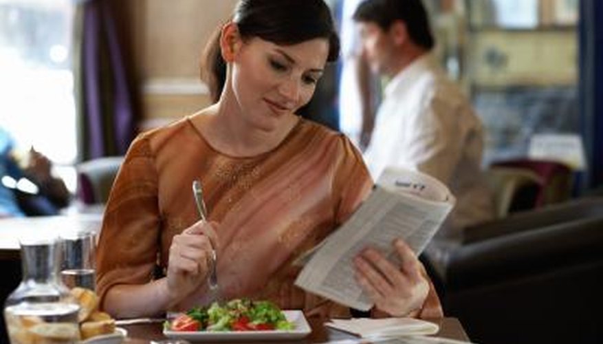 Woman eating at restaurant Woman eating at restaurant