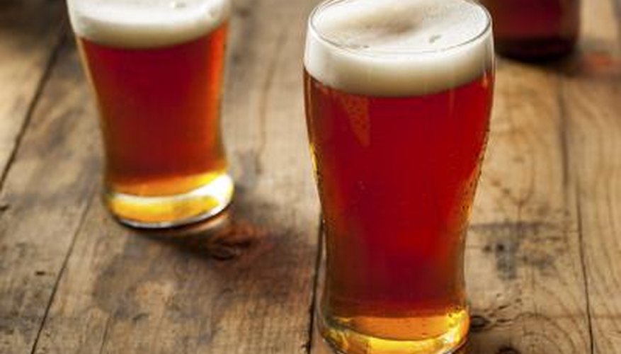 Two glasses of beer on a wood table. Two glasses of beer on a wood table.