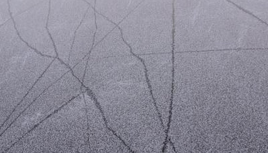 Photo Credit: Hemera Technologies/AbleStock.com/Getty Images Cracked pavement from an earthquake's damage.
