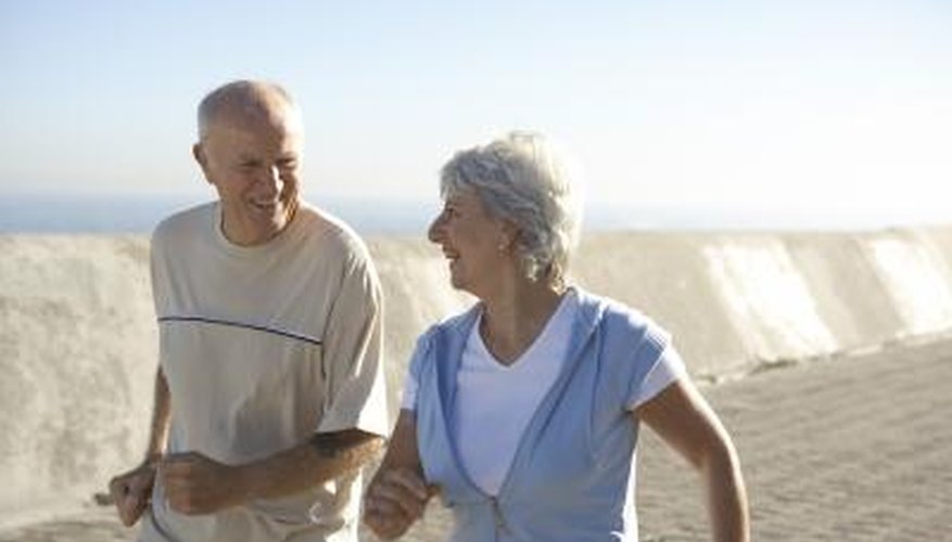A couple jogs together on the beach. A couple jogs together on the beach.