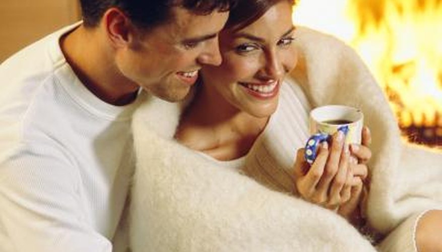man cozying up to woman in front of fireplace man cozying up to woman in front of fireplace