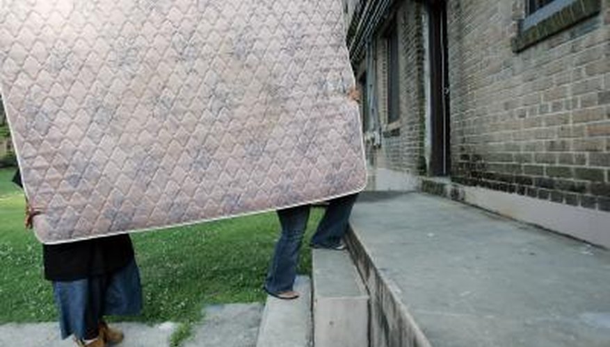 Couple carry in new mattress Couple carry in new mattress