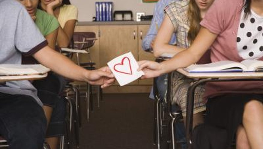 Teens passing a love note Teens passing a love note