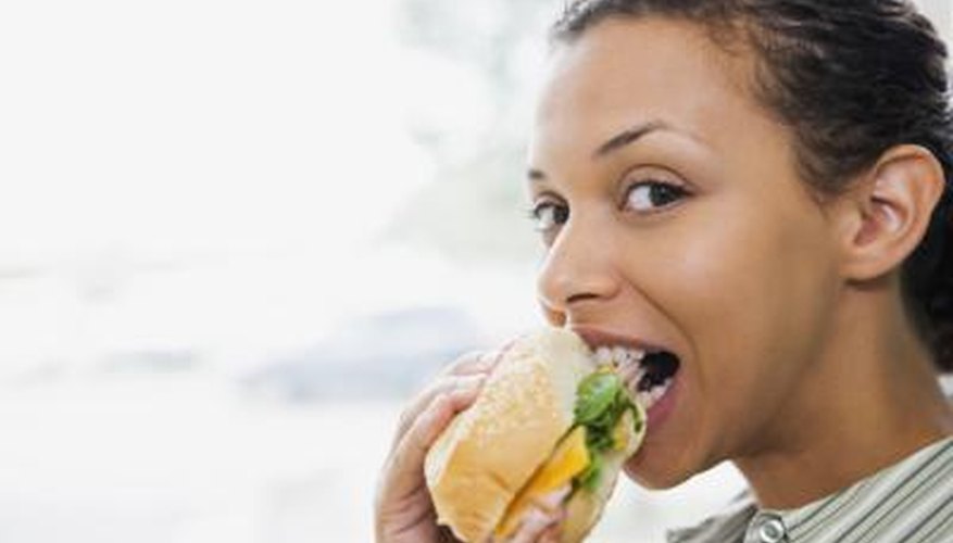 Woman eating a sandwich. Woman eating a sandwich.