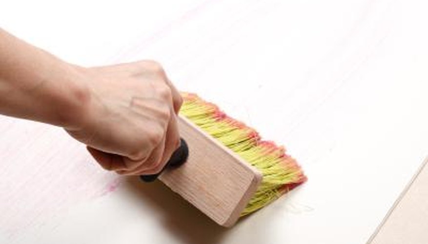 Man applying wallpaper glue Man applying wallpaper glue