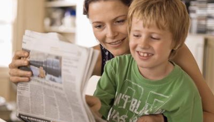 Mother and son reading paper Mother and son reading paper