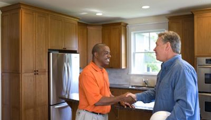 Two men shake hands in a kitchen. Two men shake hands in a kitchen.