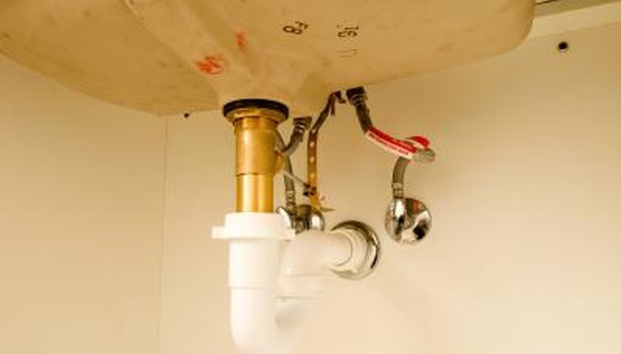 Disconnect the drain trap from the pipe that comes down from the sink and the pipe coming out of the wall. Disconnect the drain trap from the pipe that comes down from the sink and the pipe coming out of the wall.