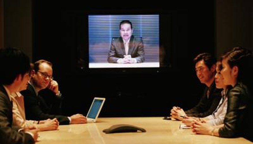 Employees meet in the conference room for a webinar. Employees meet in the conference room for a webinar.