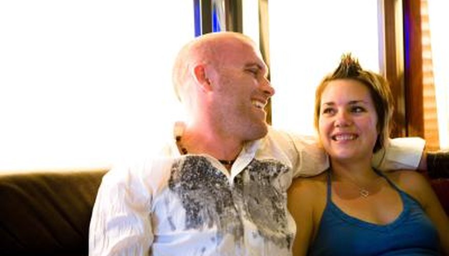 man turned toward woman on couch with arm around her man turned toward woman on couch with arm around her
