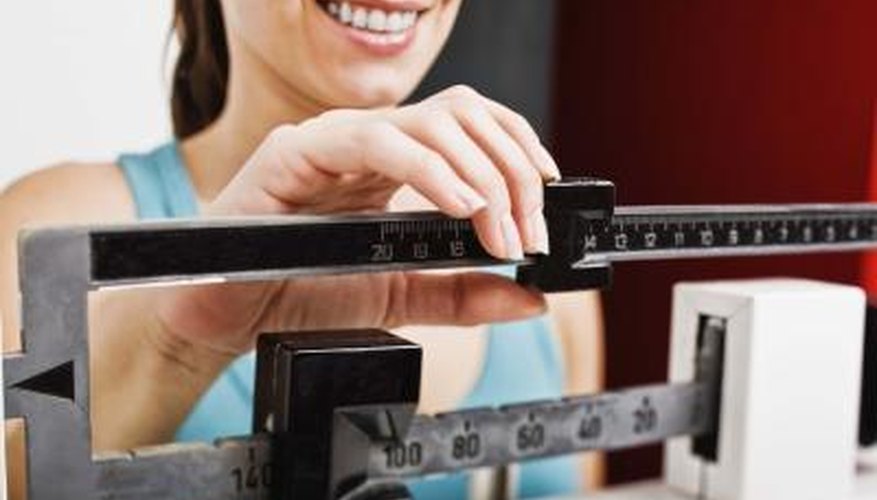 Woman taking weight on scale Woman taking weight on scale