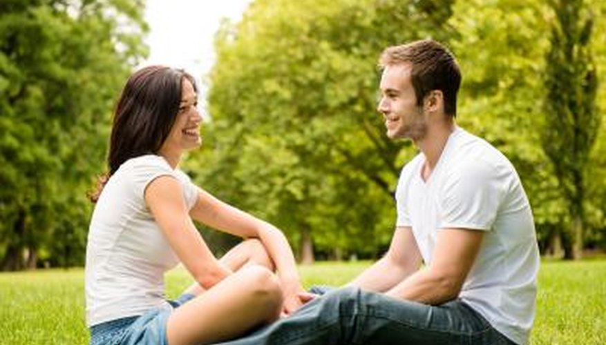 man and woman talking in park man and woman talking in park