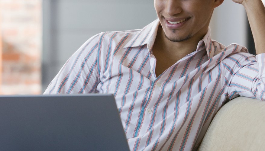 African American man looking at laptop