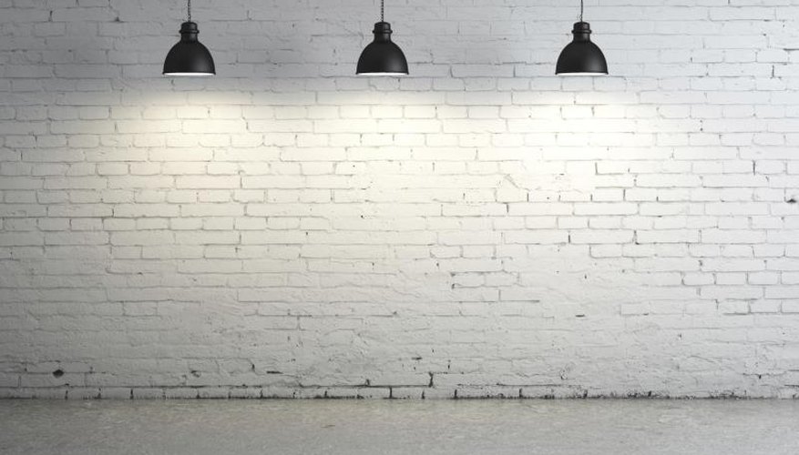 Lights against a brick wall shining on concrete floor Lights against a brick wall shining on concrete floor
