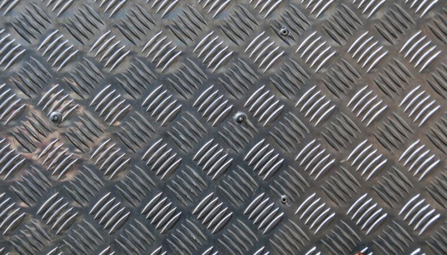 Close-up of a diamond-pattern aluminum sheet. Close-up of a diamond-pattern aluminum sheet.