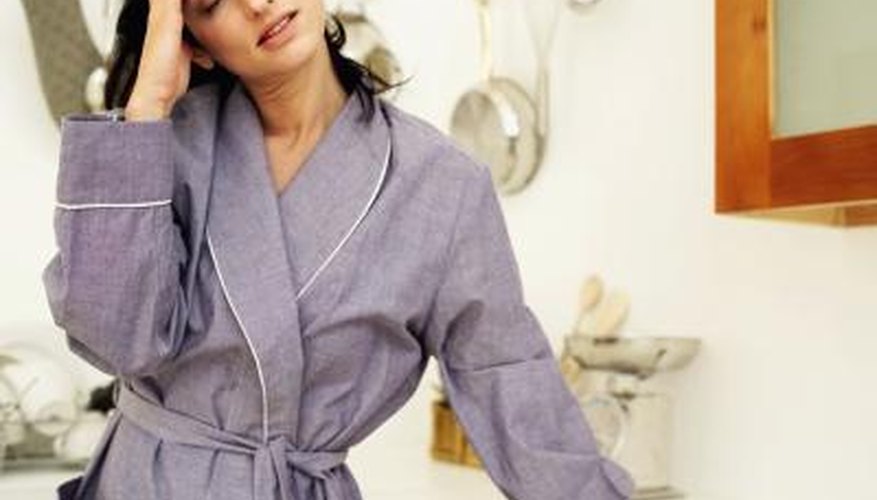 Woman wearing a robe, feeling dizzy. Woman wearing a robe, feeling dizzy.
