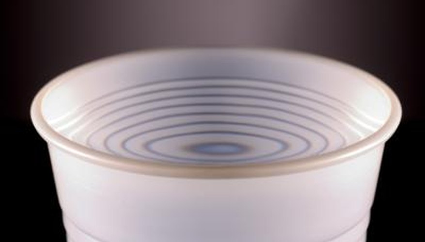 Close up cup of water with vinegar inside. Close up cup of water with vinegar inside.